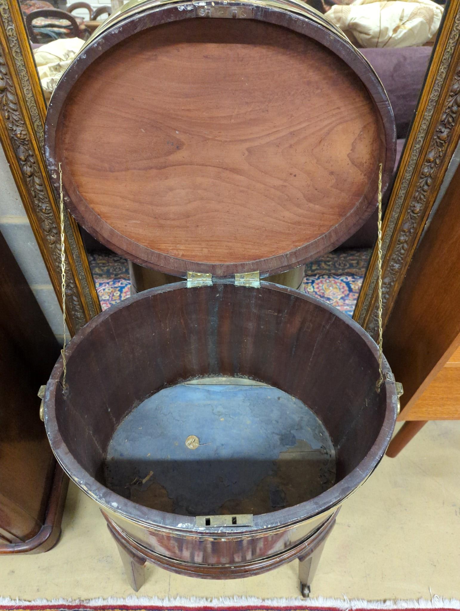 A George III mahogany triple brass bound oval wine cooler on stand, width 56cm, depth 43cm, height 78cm